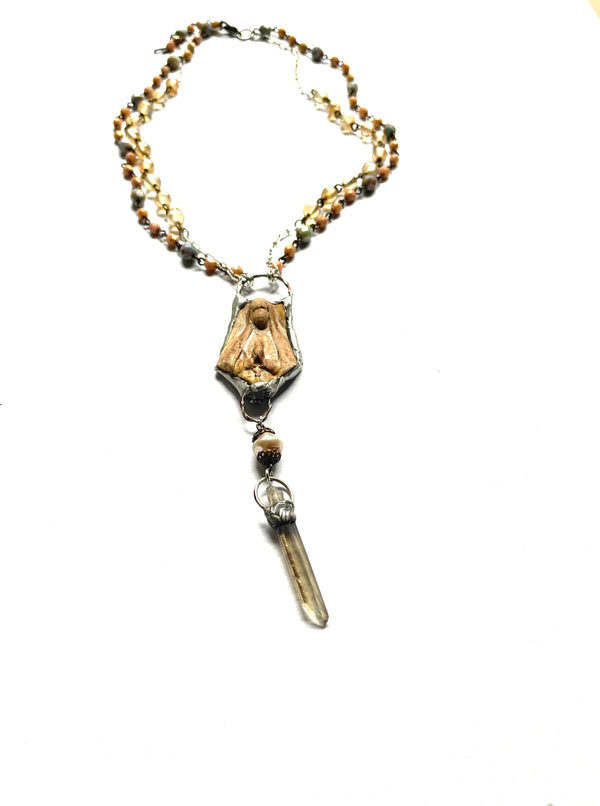 2 layers of beaded chain necklace. peach, green, gold glass beads, a single pearl and a pewter silver bezel wraps a smokey quartz crystal point. silver chain, clasp and beaded extender, ceramic pendant of the Virgin Mary, golden brown in color, in a pewter bezel